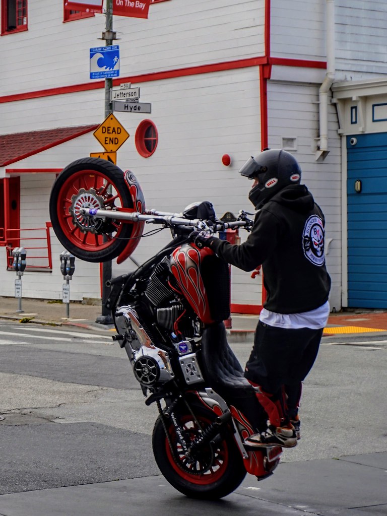 Johny Vino action photograph of a motorcycle stunt on the street