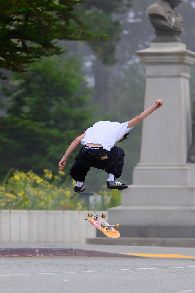 Johny Vino action photograph of a skateboarder jumping on a hill
