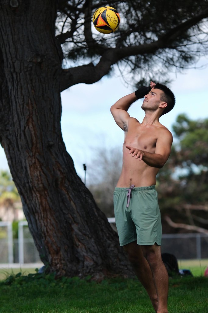 Johny Vino action photograph of a soccer header near trees