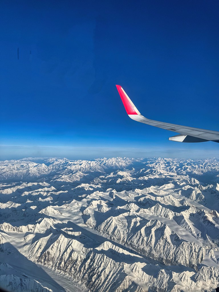 Johny Vino nature photograph of snowy mountains from an airplane window
