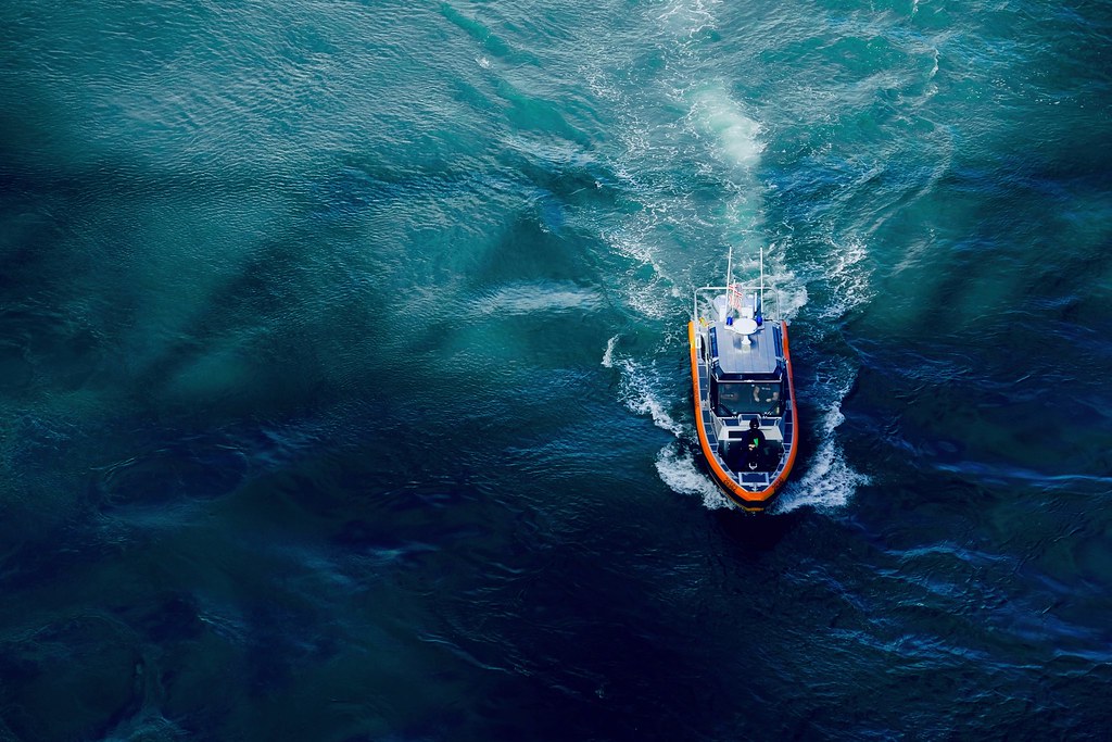 Johny Vino drone nature photograph of a boat wake in blue ocean water