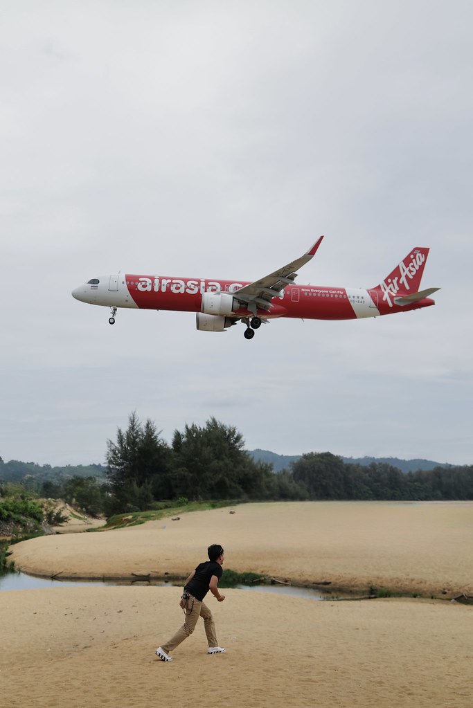 Johny Vino still life photograph of an airplane landing near a beach