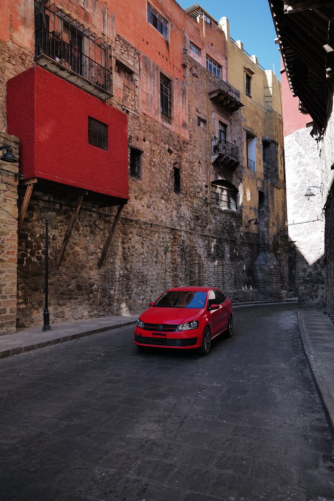 Johny Vino still life photograph of a red car on a narrow street