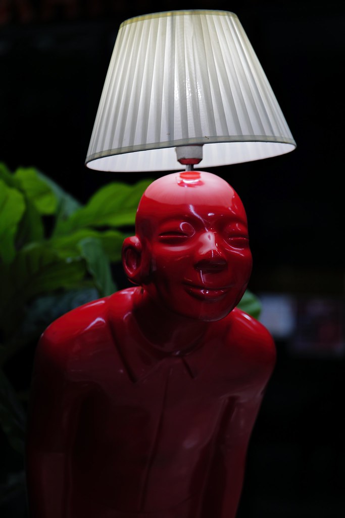 Johny Vino still life photograph of a red statue lamp