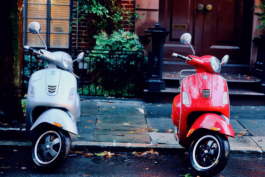 Johny Vino still life photograph of red and white Vespa scooters